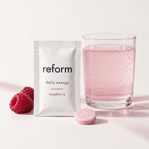 Reform Daily Energy Raspberry sachet, tablet and glass of pink sparkling water